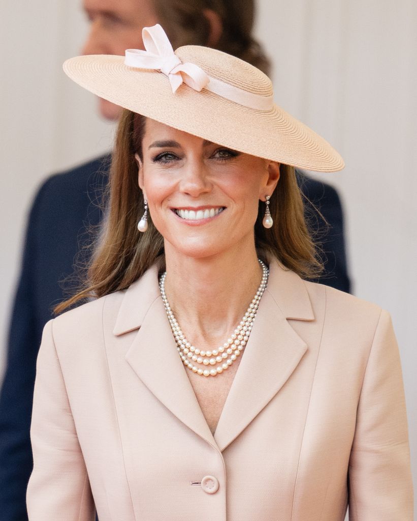 Kate Middleton smiling in pink jacket and coat