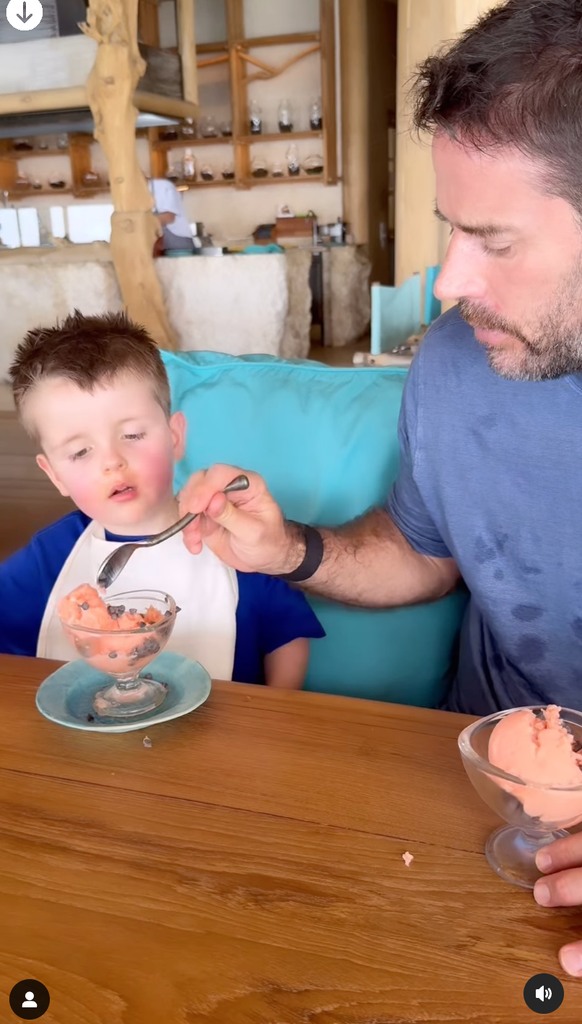 father and son eating sorbet on holiday