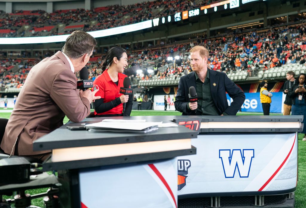 Prince Harry sits in on a TV interview during pre-game festivities 