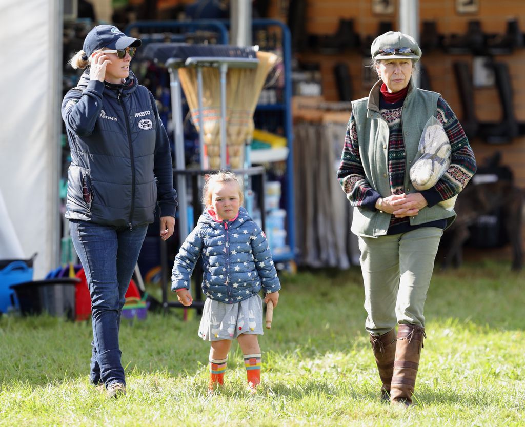 Zara Tindall in a cap looking at Princess Anne next to her daughter Mia Tindall
