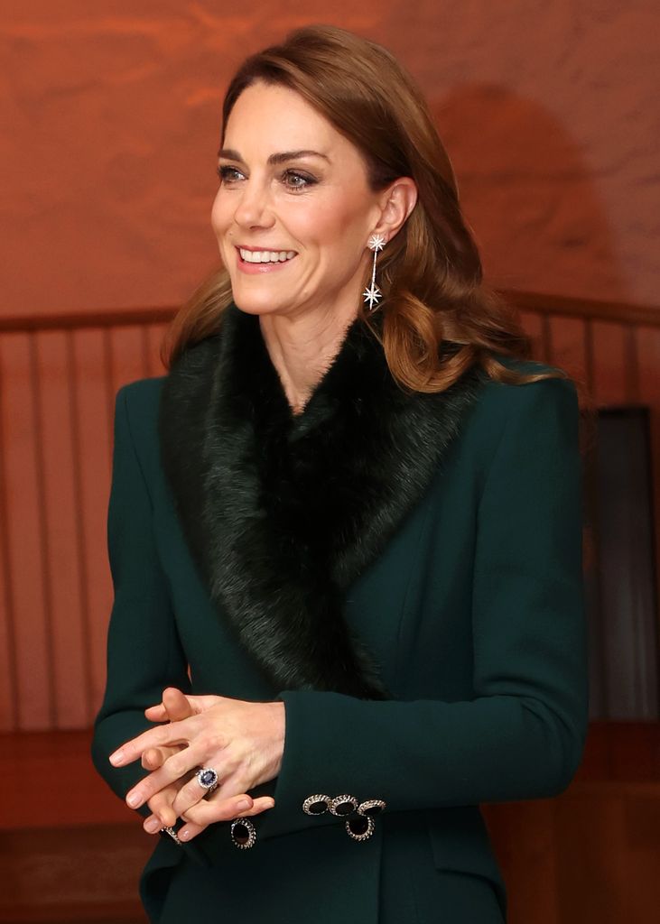 Kate looked glorious in her festive green coat by Catherine Walker, topped with a Troy London fur stole