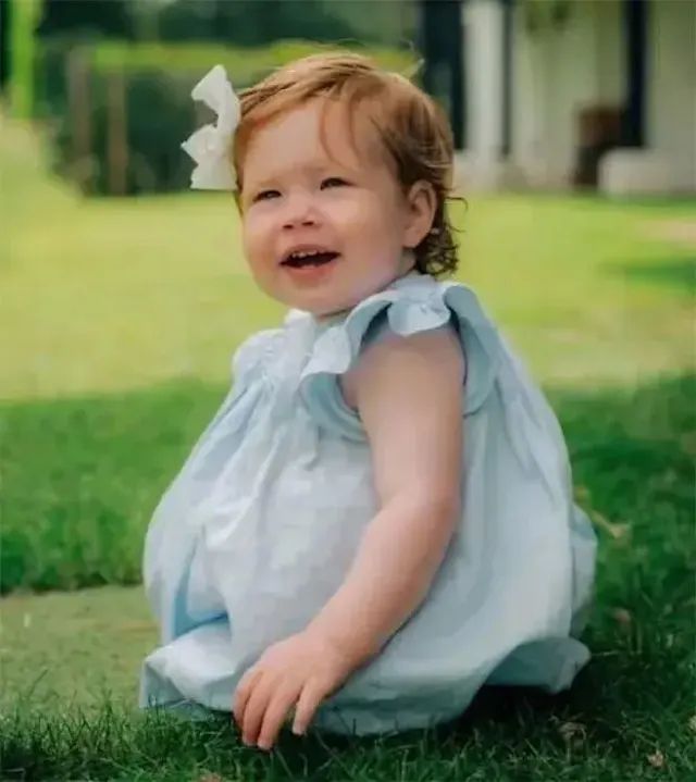 Princess Lilibet smiling on the grass