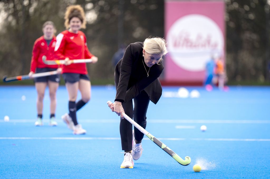 Sophie hits the hockey ball
