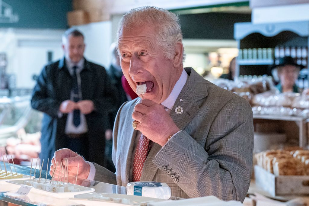 PENRITH, UNITED KINGDOM - APRIL 06: Prince Charles, Prince of Wales tastes some Cheese called, Love Ewe as he marks the 50th anniversary of Tebay Services on April 06, 2022 in Penrith, Cumbria, United Kingdom. His Royal Highness toured Tebay Services, meeting with apprentices taking part on the butchery training scheme, visiting the cheese section, the lifestyle section and met a local producer of wool, before unveiling a plaque to commemorate his visit and celebrating Tebay Services 50th anniversary. (Photo by Arthur Edwards-WPA Pool/Getty Images)