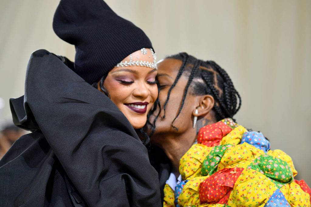 ASAP Rocky kissing Rihanna on the cheek as she smiles at the Met Gala