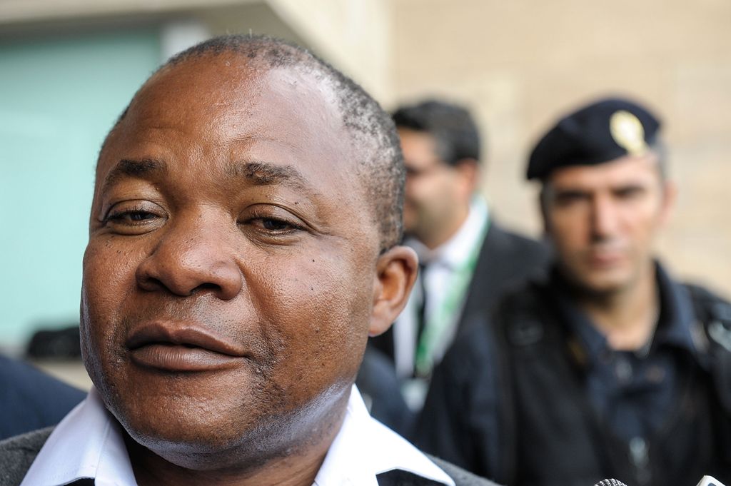 Patrick Lumumba with police officers behind him