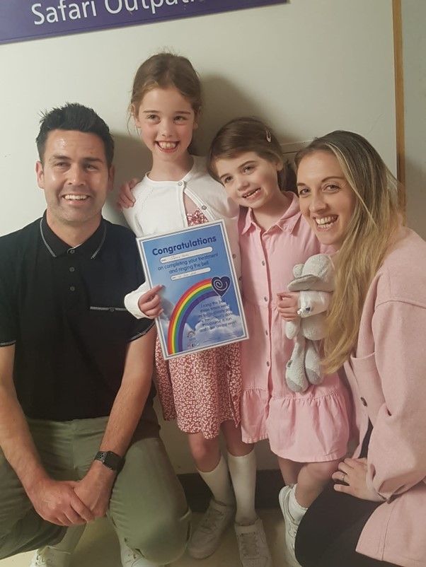 two little girls with mum and dad smiling