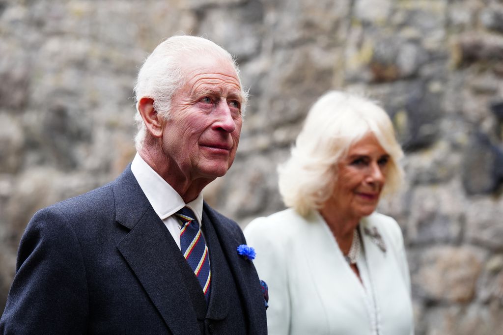 king charles and queen camilla looking serious 