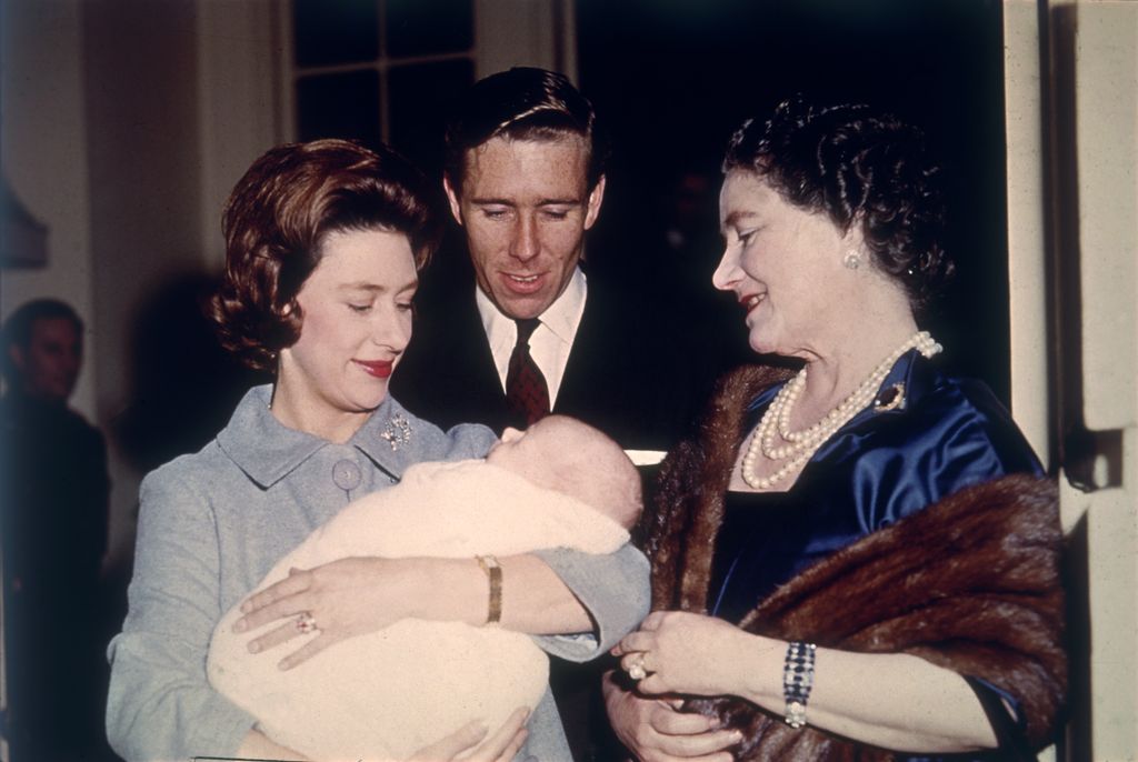 Princess Margaret holding a baby David Armstrong-Jones. Also in the photo are Antony Armstrong-Jones and the Queen Mother