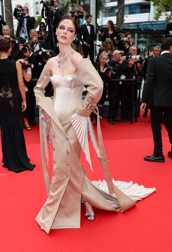 Coco Rocha attends the "The Apprentice" Red Carpet at the 77th annual Cannes Film Festival at Palais des Festivals in a Robert Wun SS24 Couture dress
