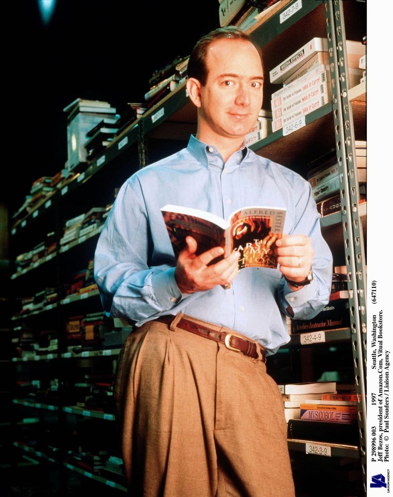 Jeff Bezos holds book in Amazon warehouse in 1997