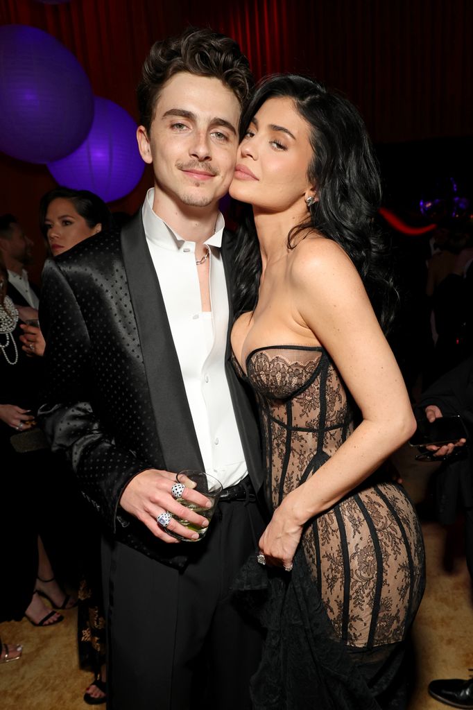 kylie jenner pressing face against timothee chalamet cheek posing for photo