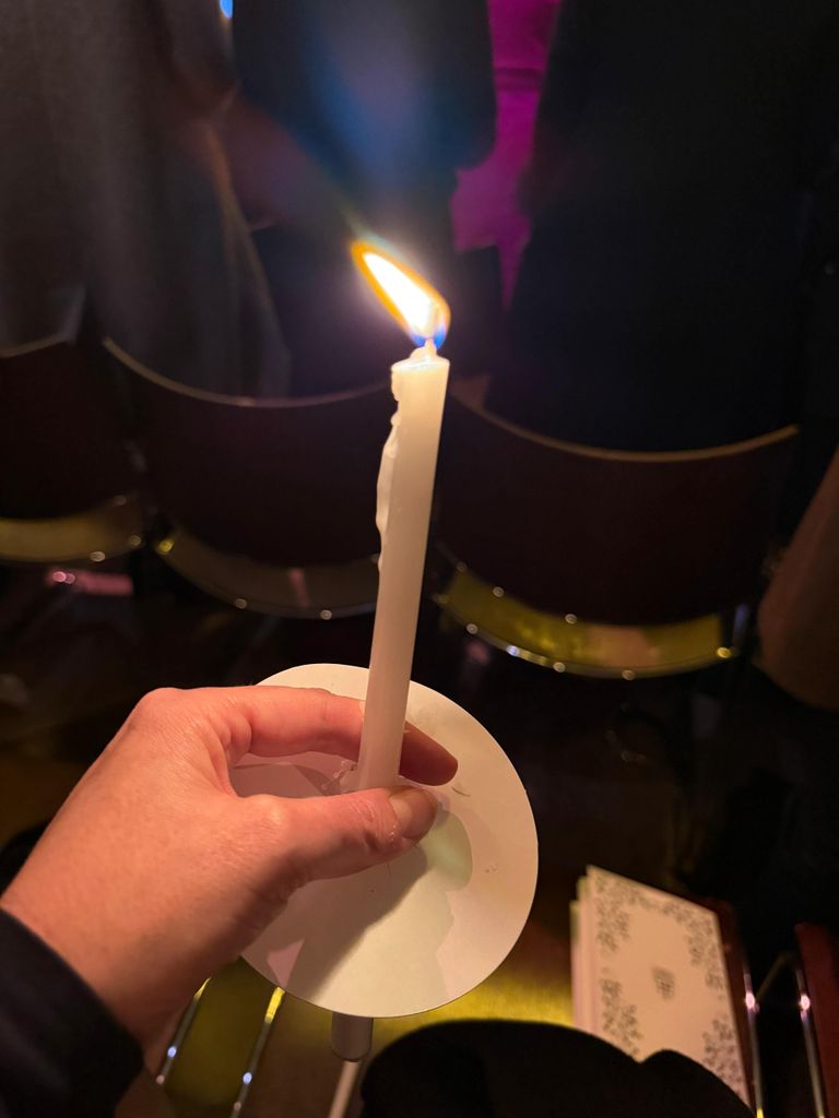 Emily Nash photo of candle inside Together at Christmas concert 