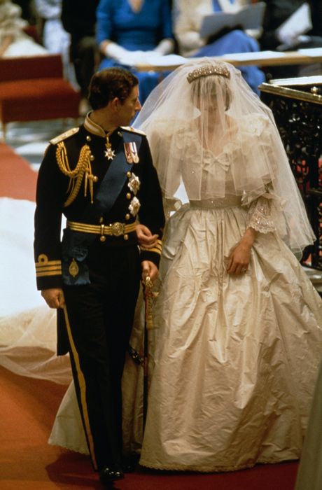 Princess Diana and Prince Charles arm in arm at their wedding