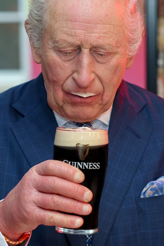 Britain's King Charles III tastes a pint of Guinness during his visit to officially open the Guinness Open Gate Brewery 