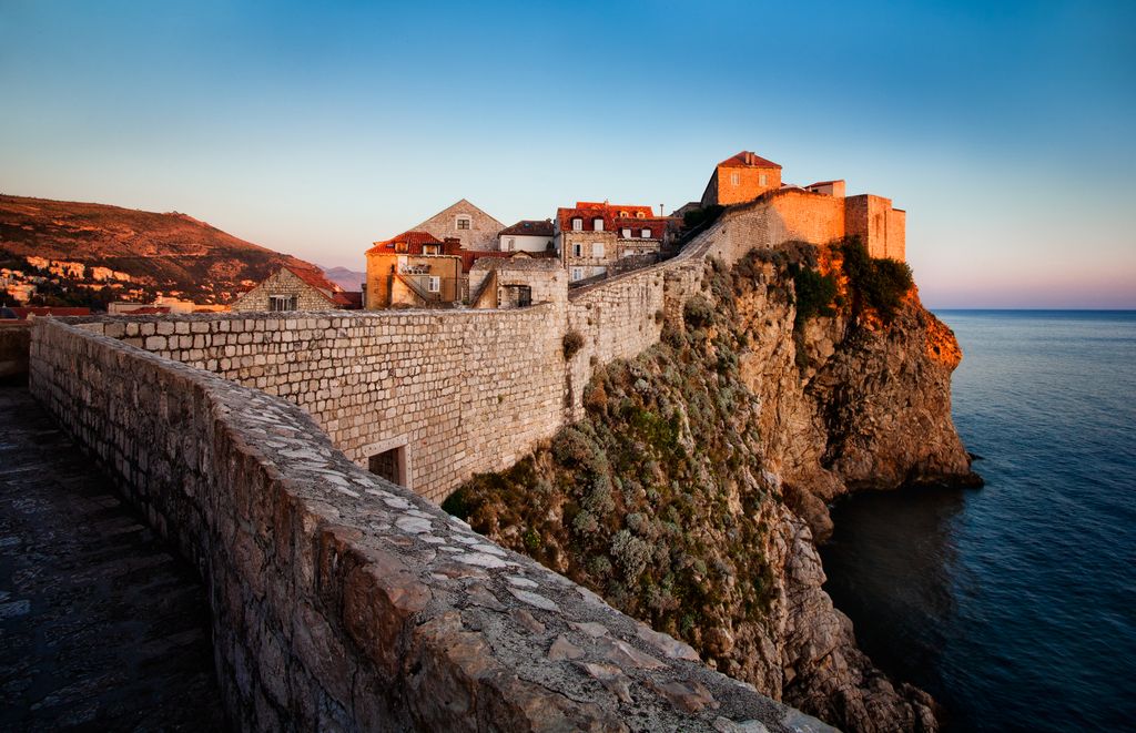 The old town of Dubrovnik is surrounded by old, solid walls, protecting citizens of old and attracting tourists in more modern times.