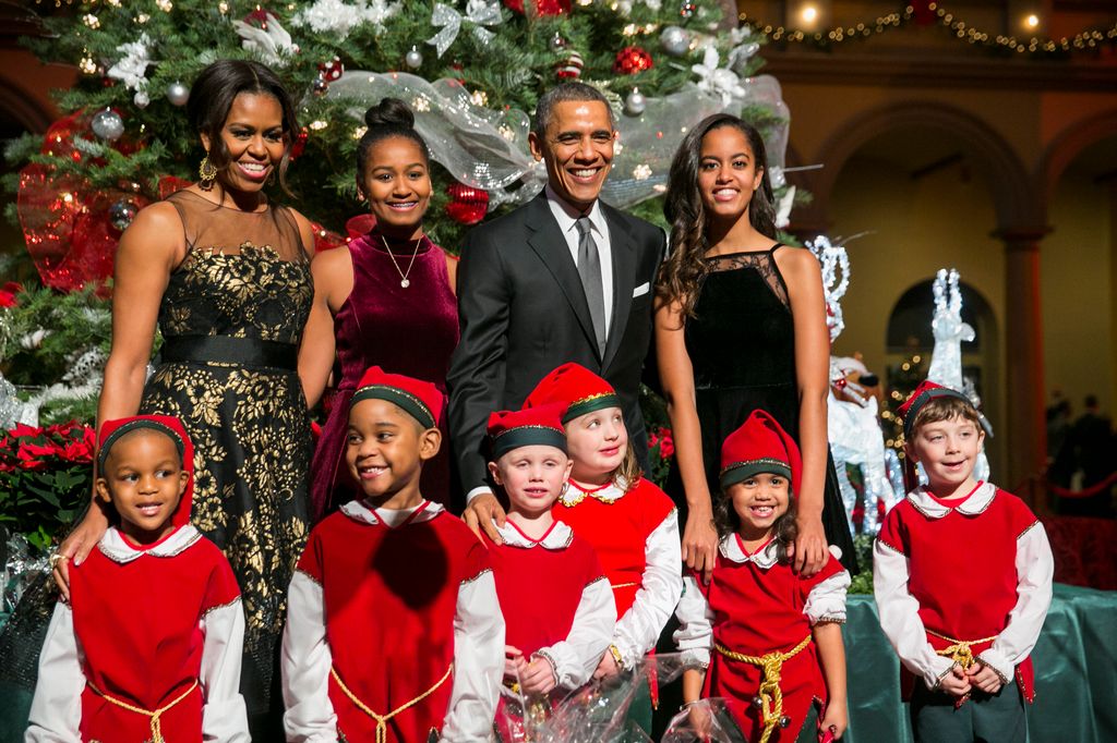 President Barack Obama, first lady Michelle Obama and daughters Sasha and Malia pose with "elves" prior to the taping of TNT's "Christmas in Washington" program in Washington, D.C.