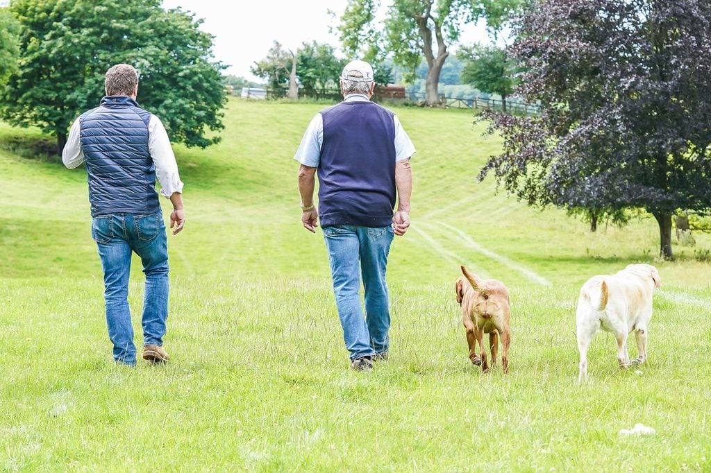Peter Phillips and Captain Mark Phillips walk with their dogs at Gatcombe Park