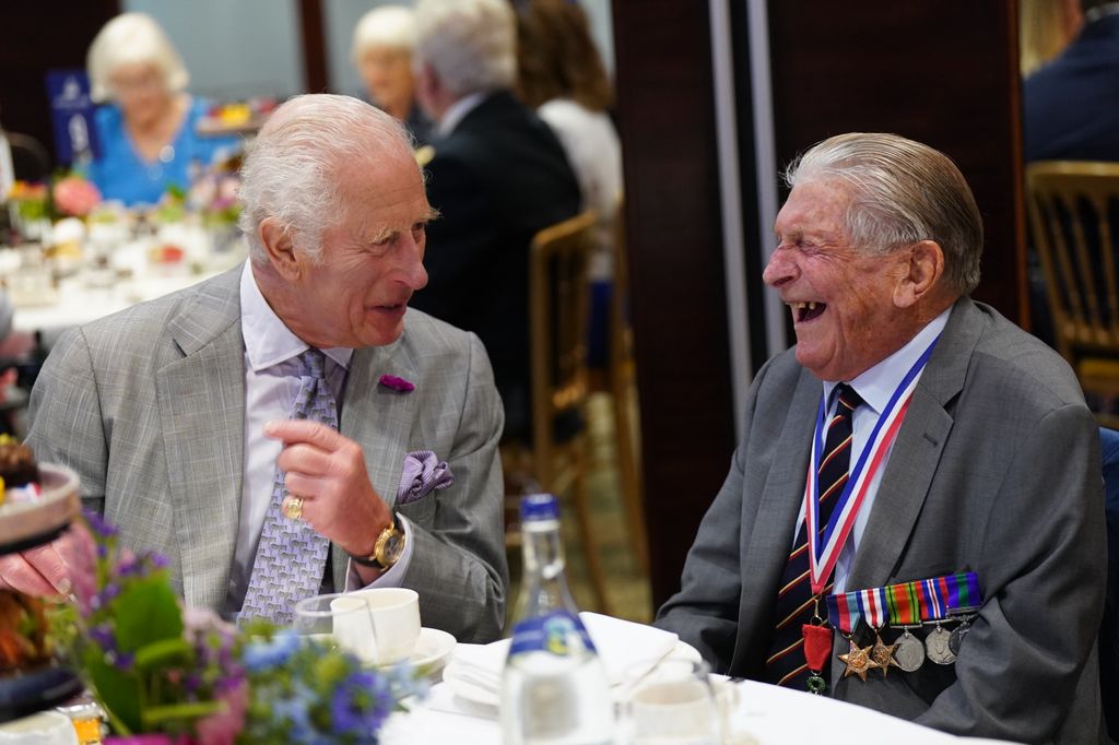 king charles chatting to veteran at tea party