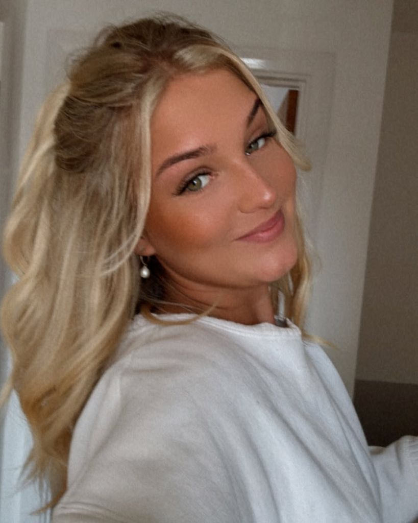 woman with blonde hair taking selfie