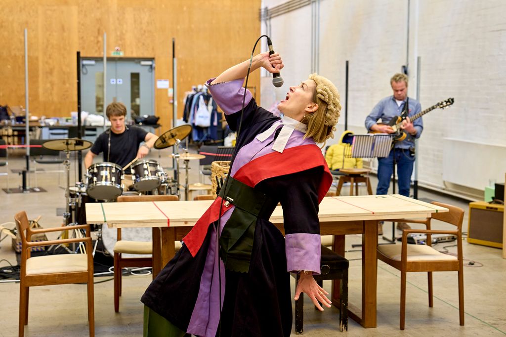 A woman sings into a microphone