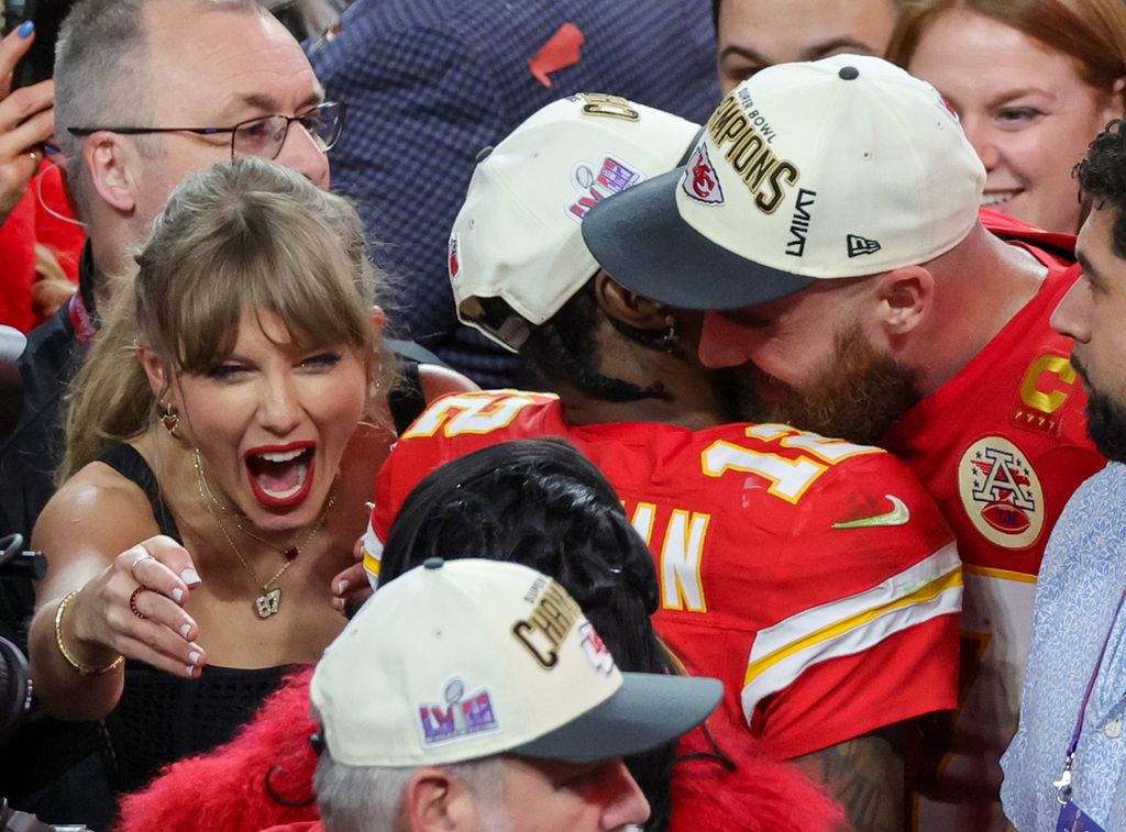 LAS VEGAS, NEVADA - FEBRUARY 11: (L-R) Taylor Swift, wide receiver Mecole Hardman Jr. #12 and tight end Travis Kelce #87 of the Kansas City Chiefs celebrate after the Chiefs' 25-22 overtime victory over the San Francisco 49ers in Super Bowl LVIII at Allegiant Stadium on February 11, 2024 in Las Vegas, Nevada. (Photo by Ethan Miller/Getty Images)