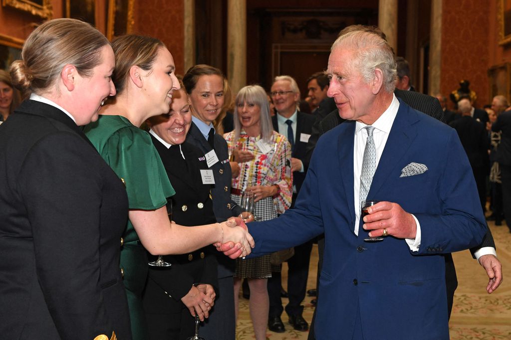 King Charles greets guests at palace reception