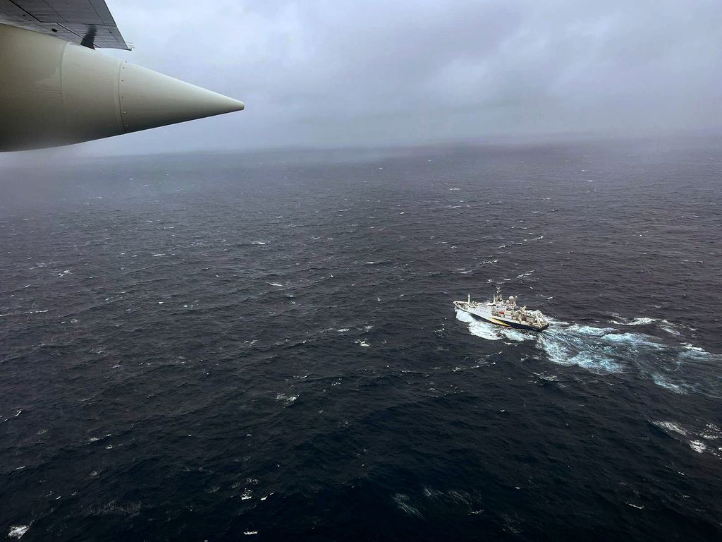 In this U.S. Coast Guard handout, a Coast Guard Air Station Elizabeth City, North Carolina HC-130 Hercules airplane flies over the French research vessel, L'Atalante approximately 900 miles East of Cape Cod during the search for the 21-foot submersible, T