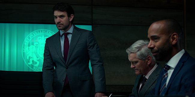 charlie cox stands in room in netflixs Treason