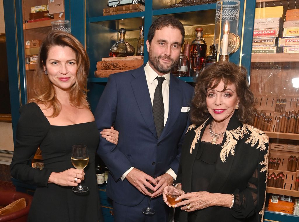 Gabriela Peacock, David Peacock and Dame Joan Collins  pose together at event