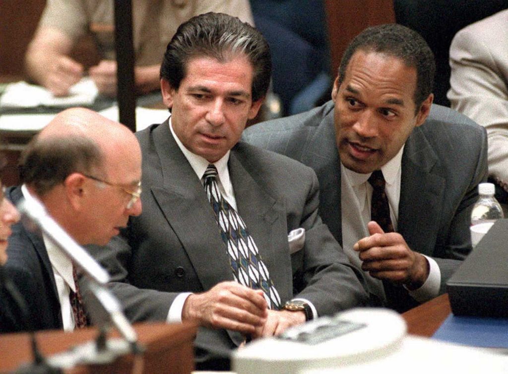 O.J. Simpson (R) consults with friend Robert Kardashian (C) and Alvin Michelson (L), the attorney representing Kardashian, during a hearing about Kardashian taking the witness stand in the O.J. Simpson murder case 03 May in Los Angeles. The prosecution wants to call Kardashian to the witness stand to question him on missing bags that O.J. Simpson took on his flight to Chicago on the night of the murders