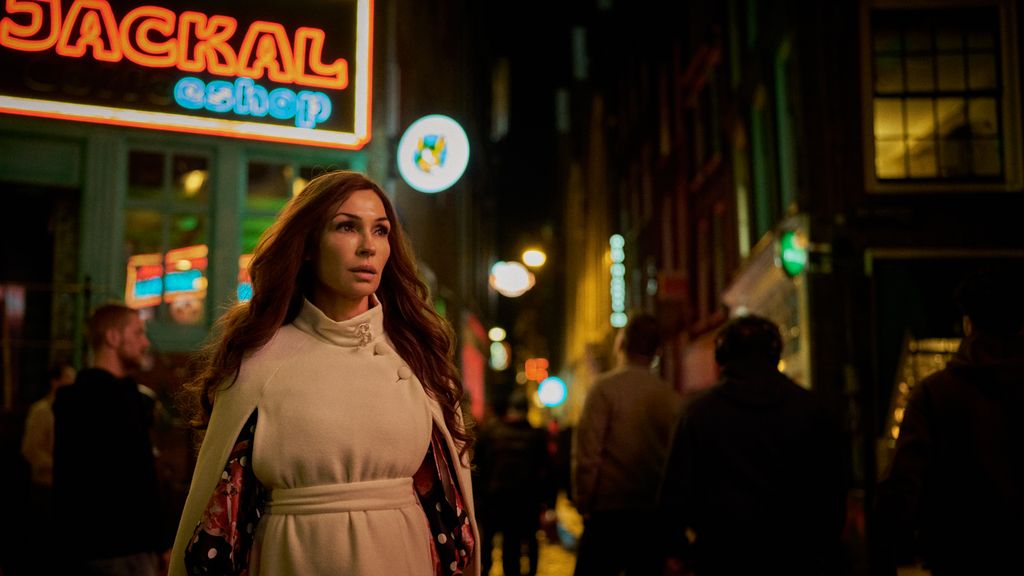 woman walking through dimly lit street