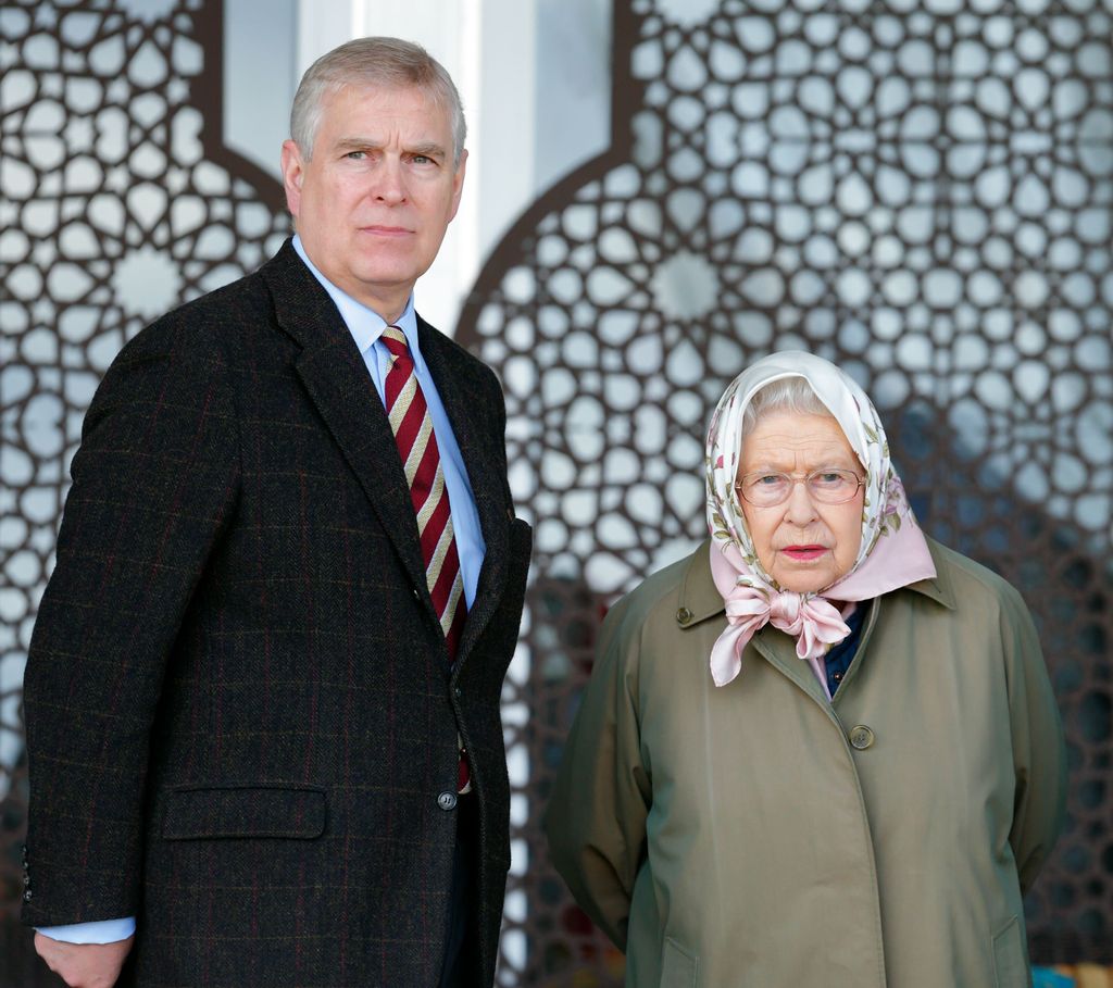 Prince Andrew standing with the late Queen