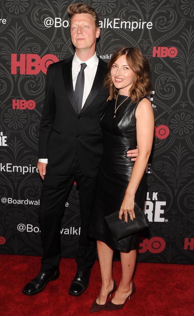 man and woman posing on red carpet