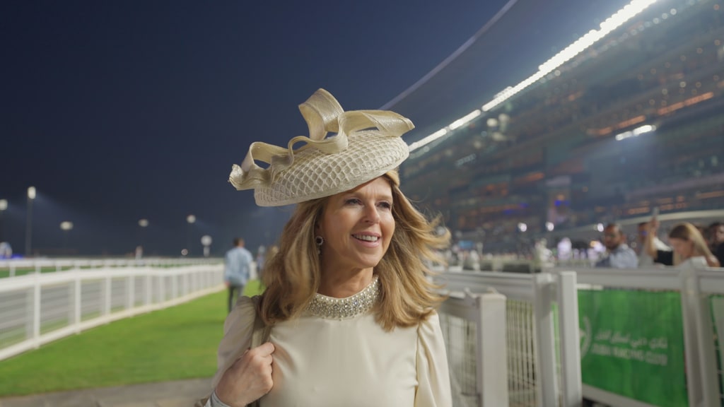 Kate Garraway at a racecourse in beige dress and hat