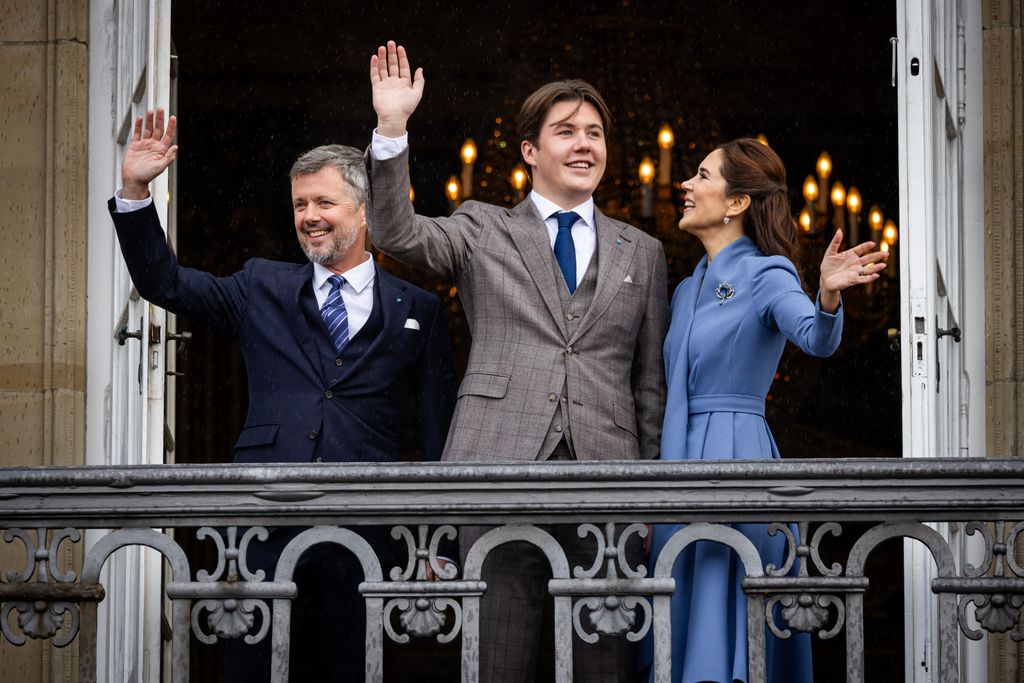 Queen Mary, King Frederik and Prince Christian waving from palace balcony