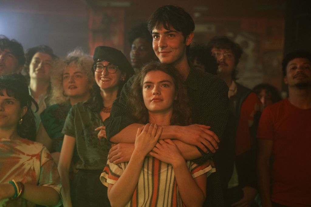 teenage girl and boy hugging in crowded room