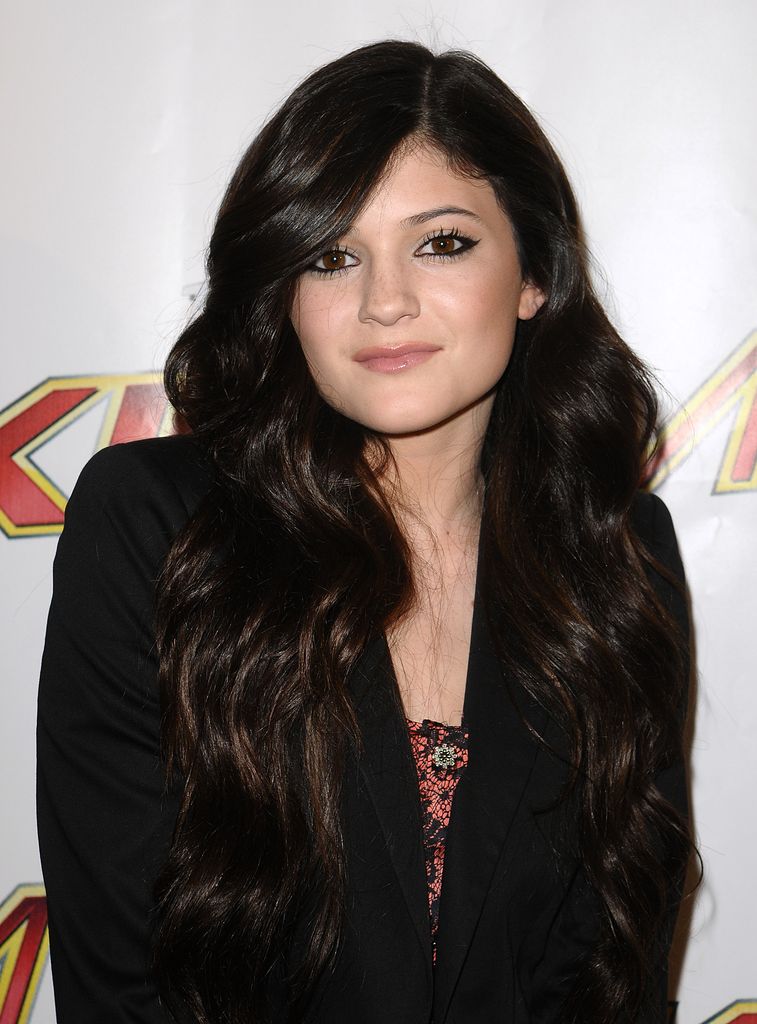 Kylie Jenner smiling in a dark outfit when she was 13 in 2010