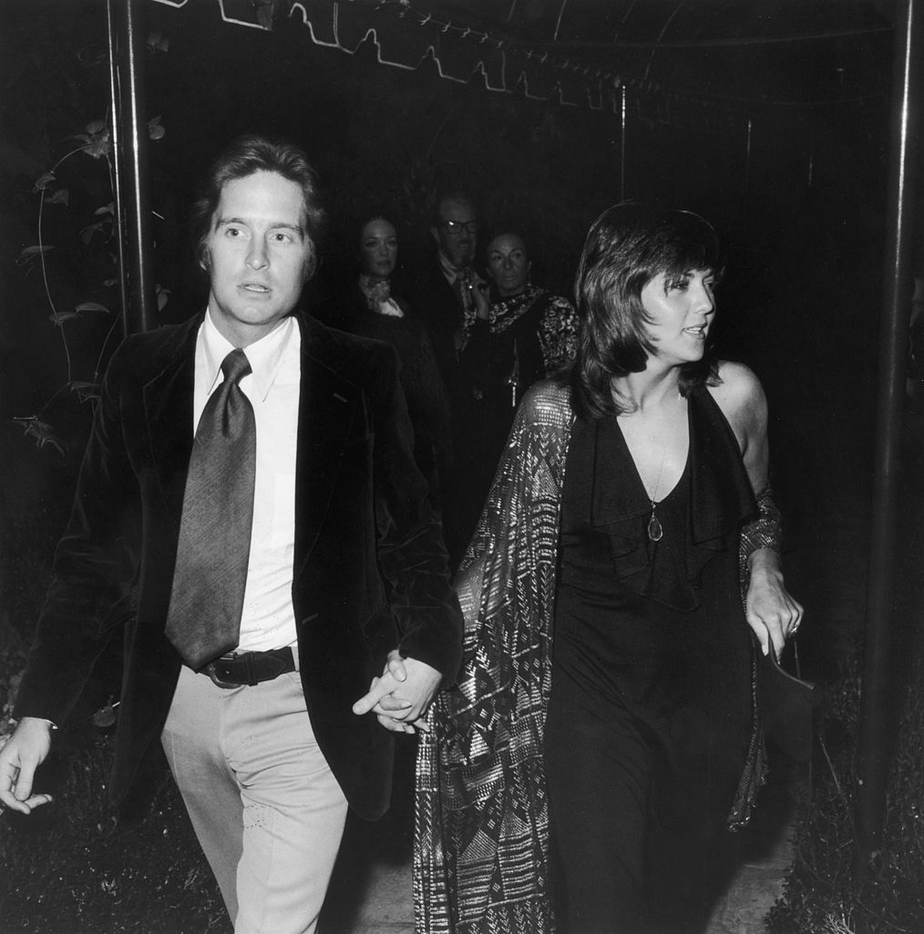 Michael Douglas and Brenda Vaccaro hold hands. 