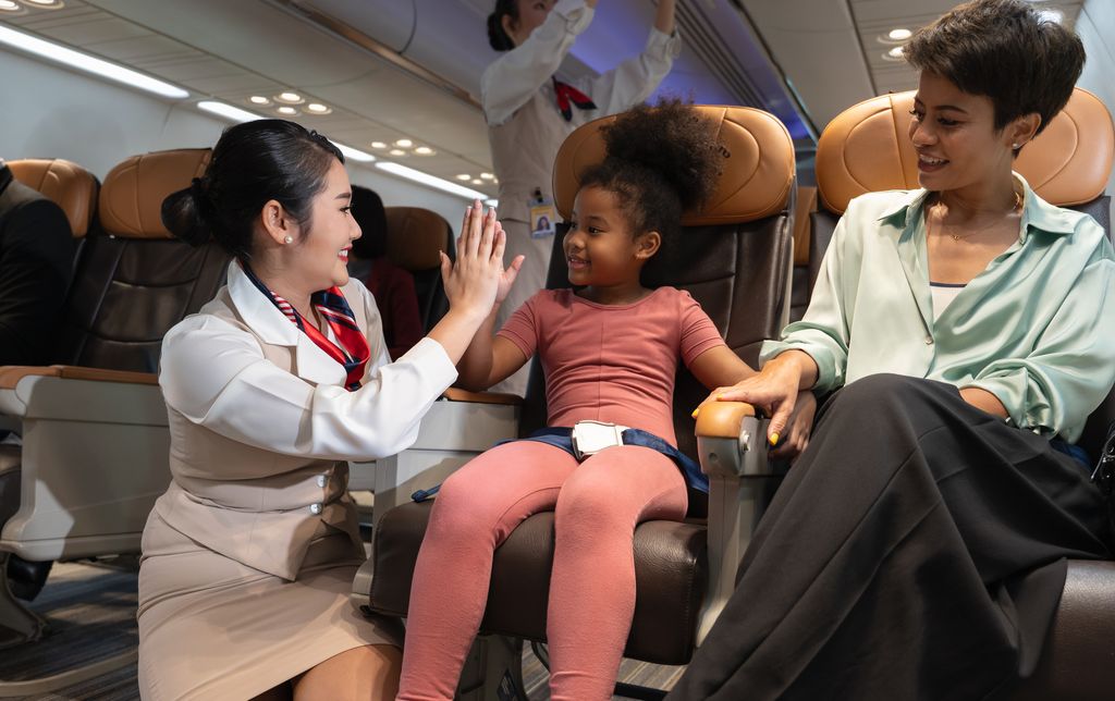 flight attendant talking to child.