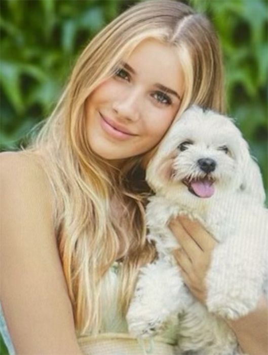 Phoebe Kay smiles with dog
