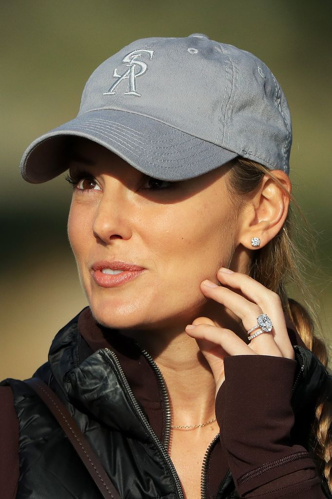 Erica Stoll sporting a cap and a diamond engagement ring