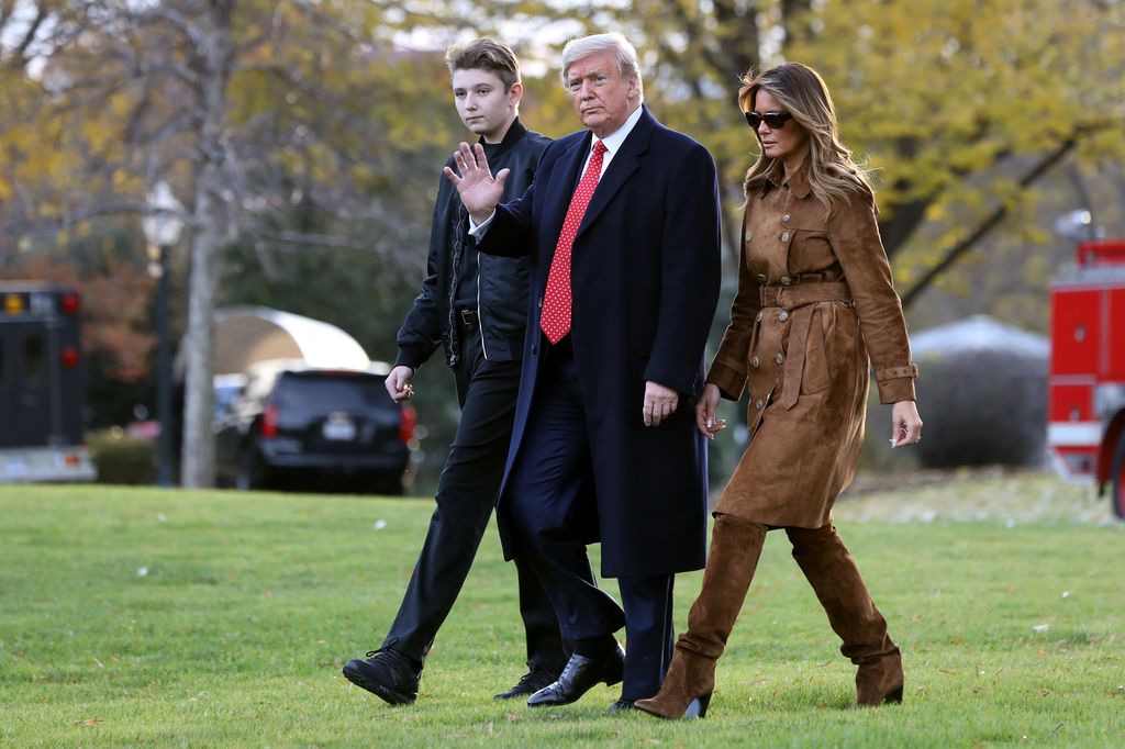 President Donald Trump, first lady Melania Trump and their son Barron Trump walk across the South Lawn in 2019