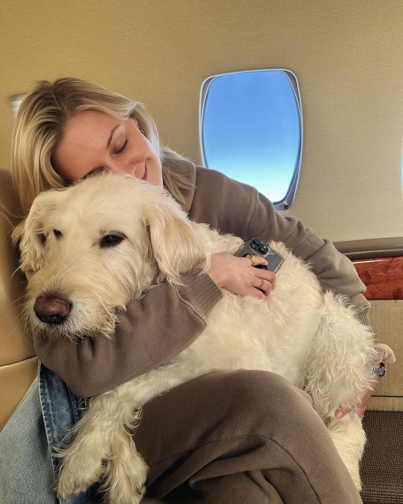 Kelsea Ballerini sits on a plane with her dog Dibs