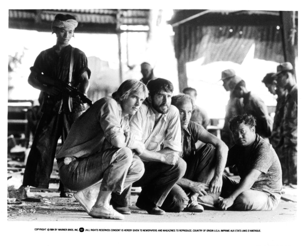 Julian Sands, Sam Waterston and John Malkovich are held at gunpoint in a scene from the film 'The Killing Fields', 1984