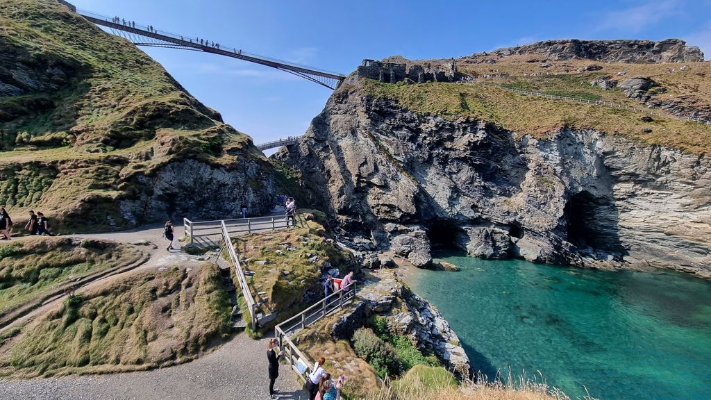 View of Merlin's Cave at Tintagel Castle with Footbridge and hiking trails in North Cornwall, England, United Kingdom.