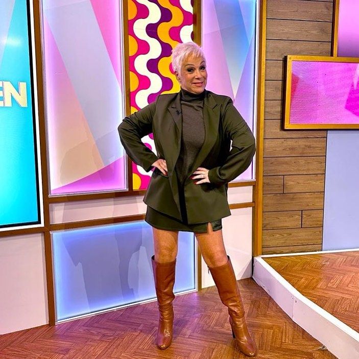 Denise Welch in knee-high boots and a mini skirt 
