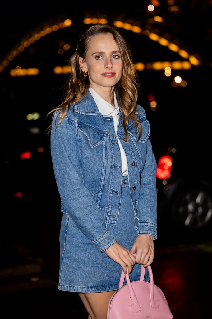 Pauline Chalamet wears denim jacket, skirt, pink bag outside Patou during the Menswear Fall Winter 2025/2026