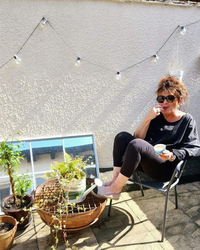Jane Minty relaxing in her garden in the sunshine