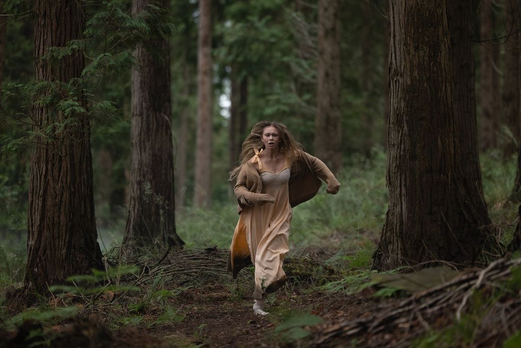 girl running through woods